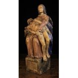 A 16th Century Style French Polychromed Carved Pieta depicting Mary holding the body of Christ,
