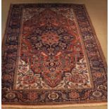 A Large Red-ground Wool Carpet with centre medallion and triple banded border,