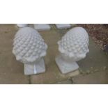 A pair of stone effect pineapple pier caps, 54cm tall