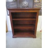 A modern oak bookcase with fixed shelves - 132cm tall x 116cm x 45cm - in good condition