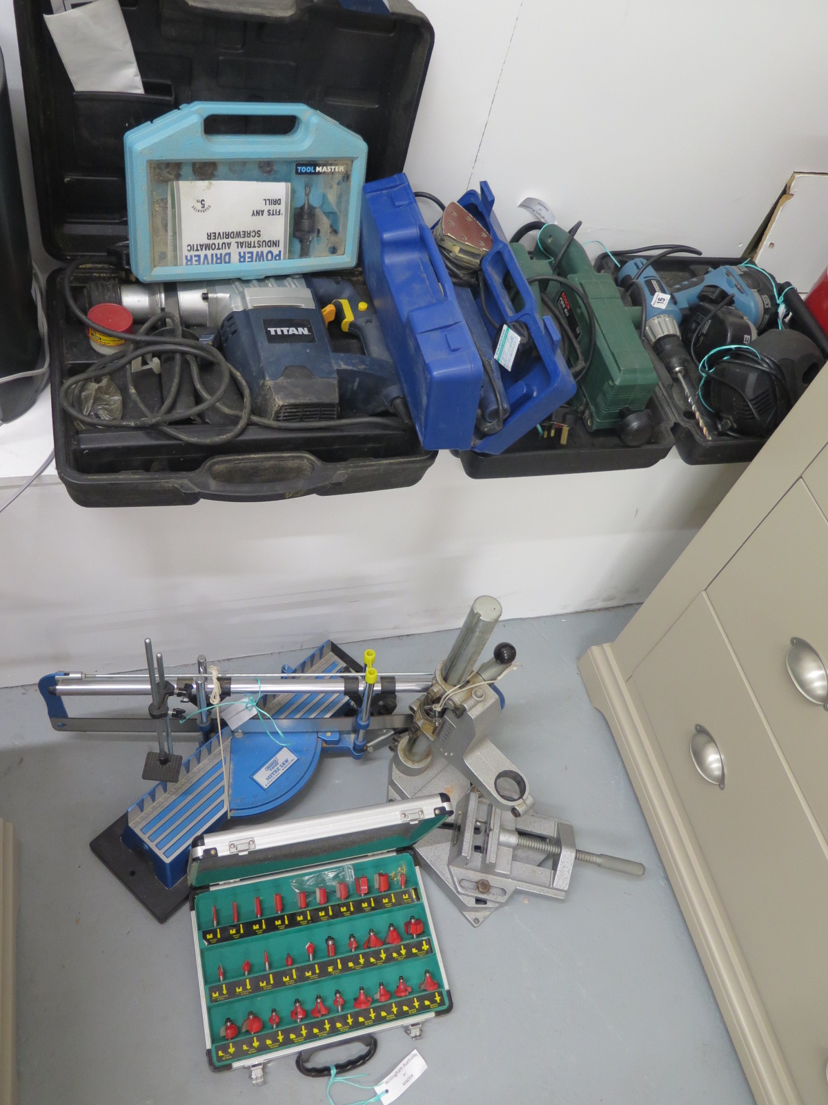 A selection of 4 power tools and attachments and a boxed set of Routers, 1 drill and 3 sanders, a