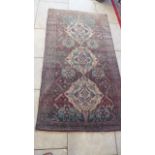 A hand knotted Persian Baluchi rug - 2.25m x 1.23m