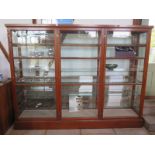 A 19th century mahogany shop display cabinet with three glazed lockable doors with keys, the