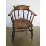 A 19th century ash and elm smokers bow armchair with a double stretcher