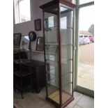 A 19th century shop display cabinet with a single door and five internal shelves with fitted locks