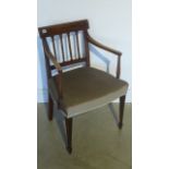 A Georgian mahogany framed armchair with carved back rail and supports raised on square tapering