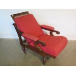 A mahogany framed campaign chair, cane back and seat folding, raised on turned supports