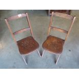 A pair of folding beech framed childs chairs