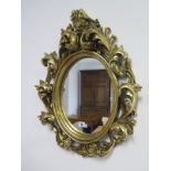 An ornate modern mirror - 63cm x 52cm