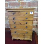 A miniature pine chest with nine drawers - Height 49cm x 33cm x 13cm