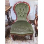 A 19th century mahogany spoon back nursing chair recently re upholstered in a green draylon fabric