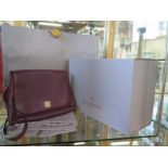 A Mulberry maroon leather shoulder bag with fold over top and magnetic catch box, cover and bag -