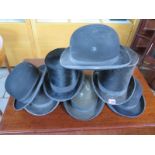 A collection of two vintage top hats and five bowler hats - various sizes and condition