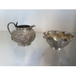 An Indian silver milk jug and sugar bowl with jungle decoration - Jug 8cm tall - total weight approx