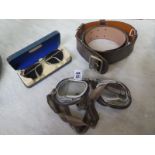 A Sam Browne belt, a pair of English goggles and a MK 12 22C/2432 medium sunglasses with case