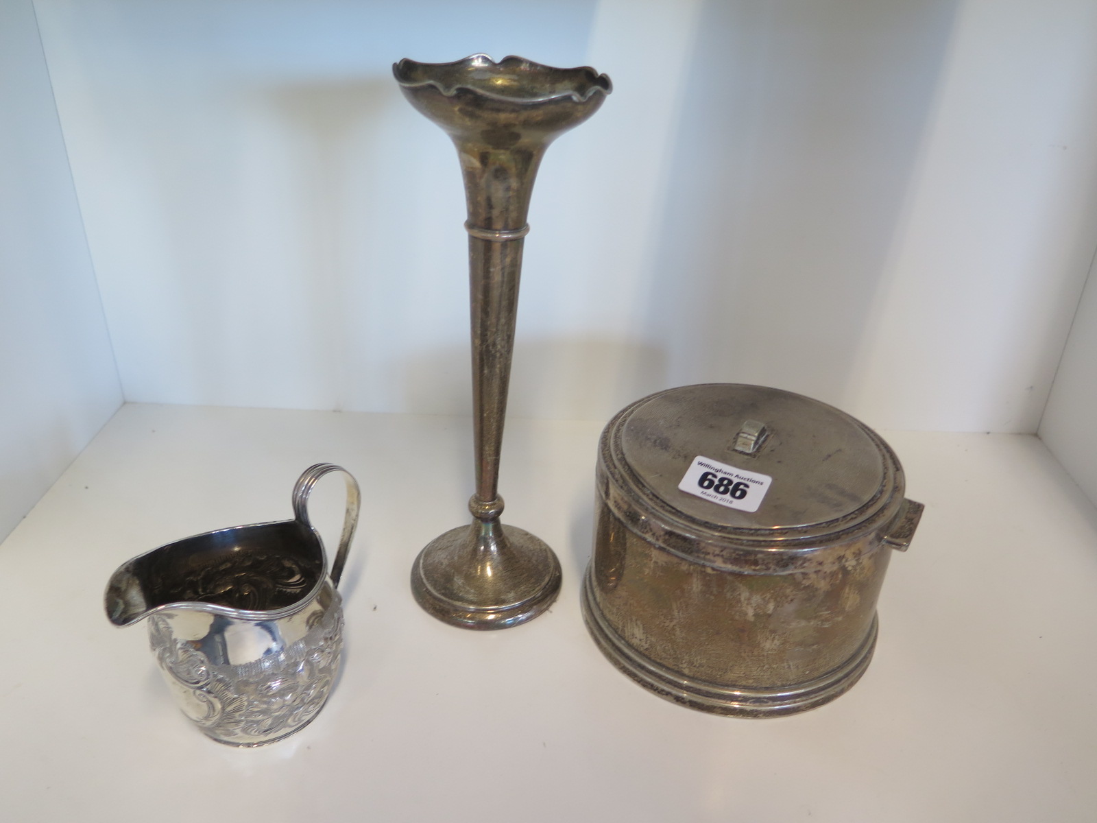 A silver lidded pot with weighted base, a silver jug and a silver vase with weighted base -