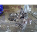 A selection of hallmarked silver items - to include napkin rings, spoons, peppers etc - varying