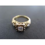 A 14ct yellow gold three stone diamond ring size L - weight approx 3.8 grams - some light scratches,