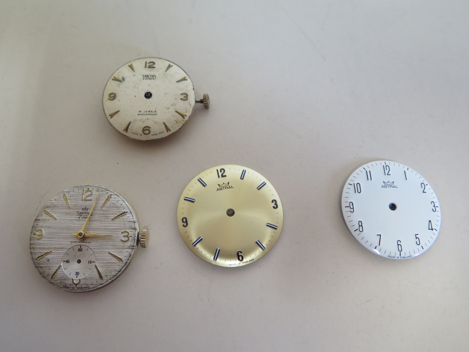 Two English made Smiths gents wristwatch movements and dials, with swinging balance wheels and two