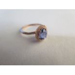 A sapphire and micropave diamond double halo ring set in 10K rose gold, stamped 10K/417 - the