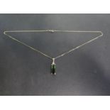 An 18ct yellow gold tourmaline and diamond pendant on a 9ct yellow gold chain - Length approx 48cm -