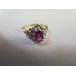 A hall marked 18ct yellow gold ruby and diamond ring - size O - approx 4 grams - ruby approx 7mm x