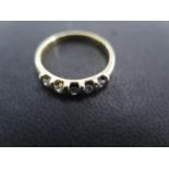 An 18ct yellow gold five stone diamond ring size N - approx weight 3.1 grams - total diamond