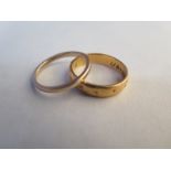 A 22ct yellow gold hallmarked band ring - size N - approx 5 grams - and a hallmarked 9ct yellow gold