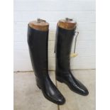 A pair of black leather riding boots by Harrods with wooden boot trees - Size 10 1/2 - stitching