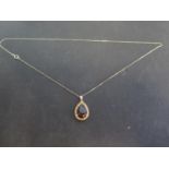 A 9ct gold smokey quartz and yellow sapphire set pendant - chain length approx 45cm - total weight