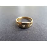 An 18ct yellow gold three stone Diamond hallmarked ring - size M - approx weight 3.2 grams - some