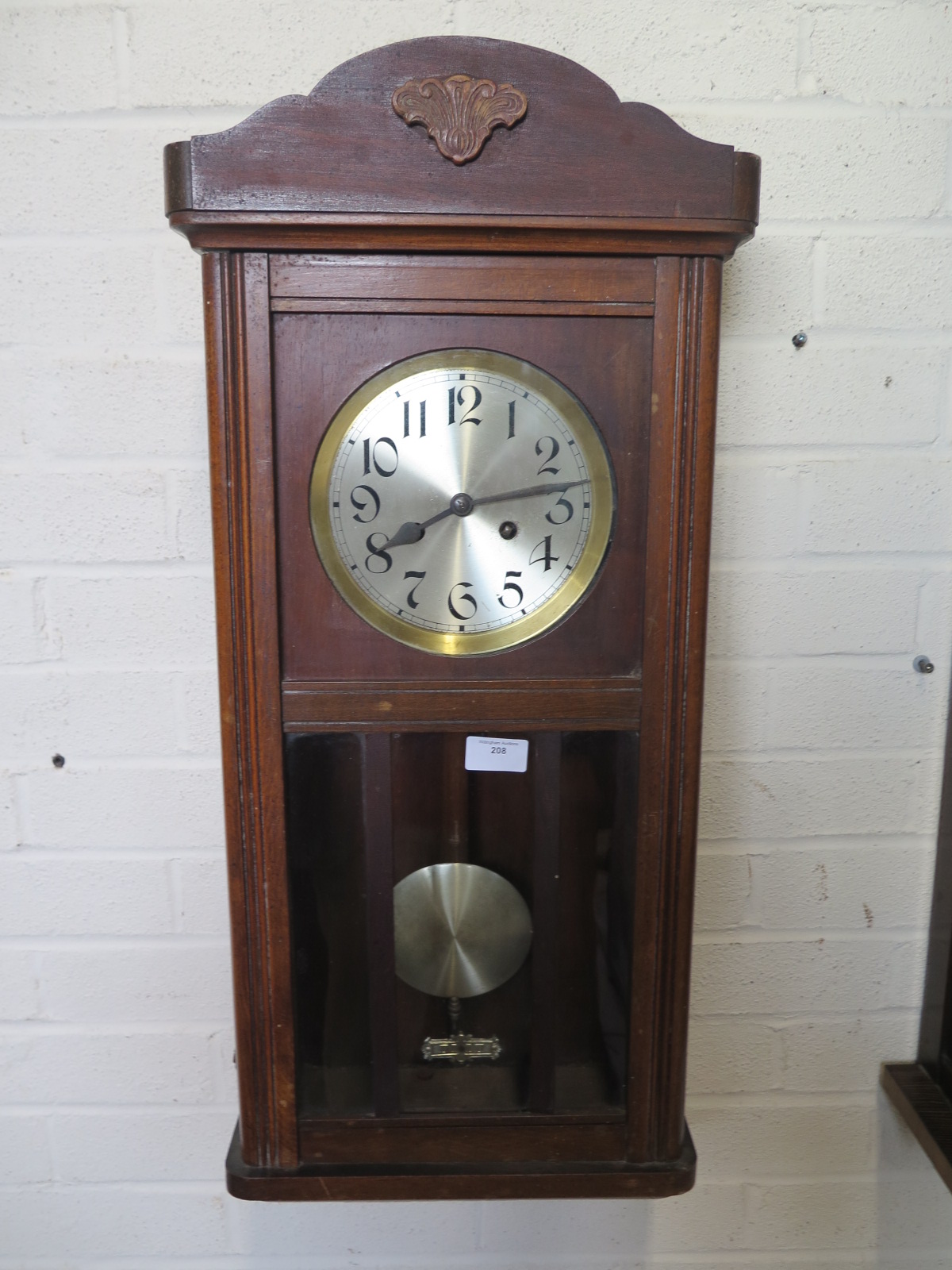 An oak eight day wall clock strikes hours and half hours