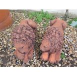 A pair of cast stone recumbent lions resting on a rectangular base after Canova - 45cm long