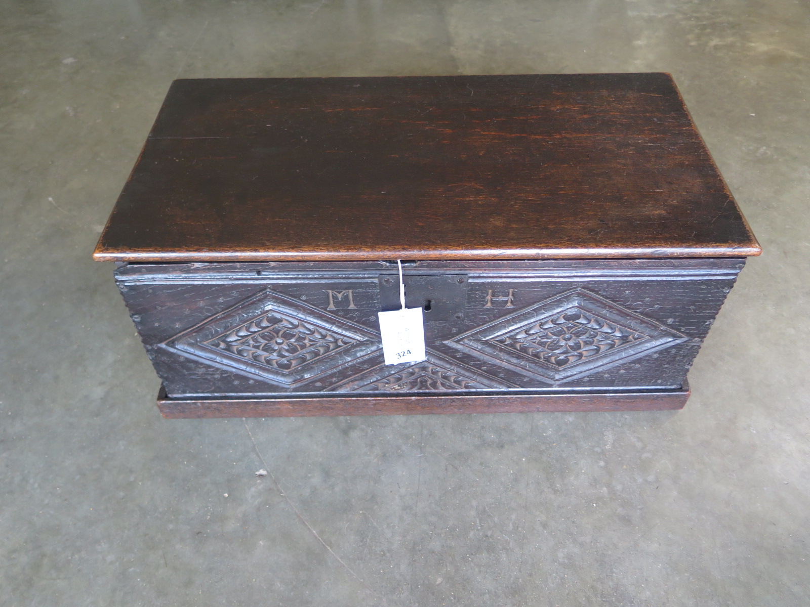 A 17th Century and later oak box with carving - 30cm tall x 69cm x 35cm