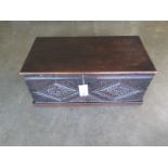 A 17th Century and later oak box with carving - 30cm tall x 69cm x 35cm