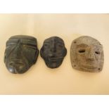 A Nephrite green stone carved mask, 9cm tall and two other stone masks