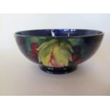 An A W Moorcroft leaf and berry decorated bowl, 7cm tall x 16.5cm diameter, overall crazing, crack