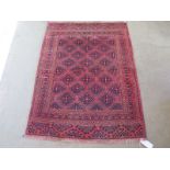 A hand knotted woollen Turkman rug - 1.4m x 1.03m