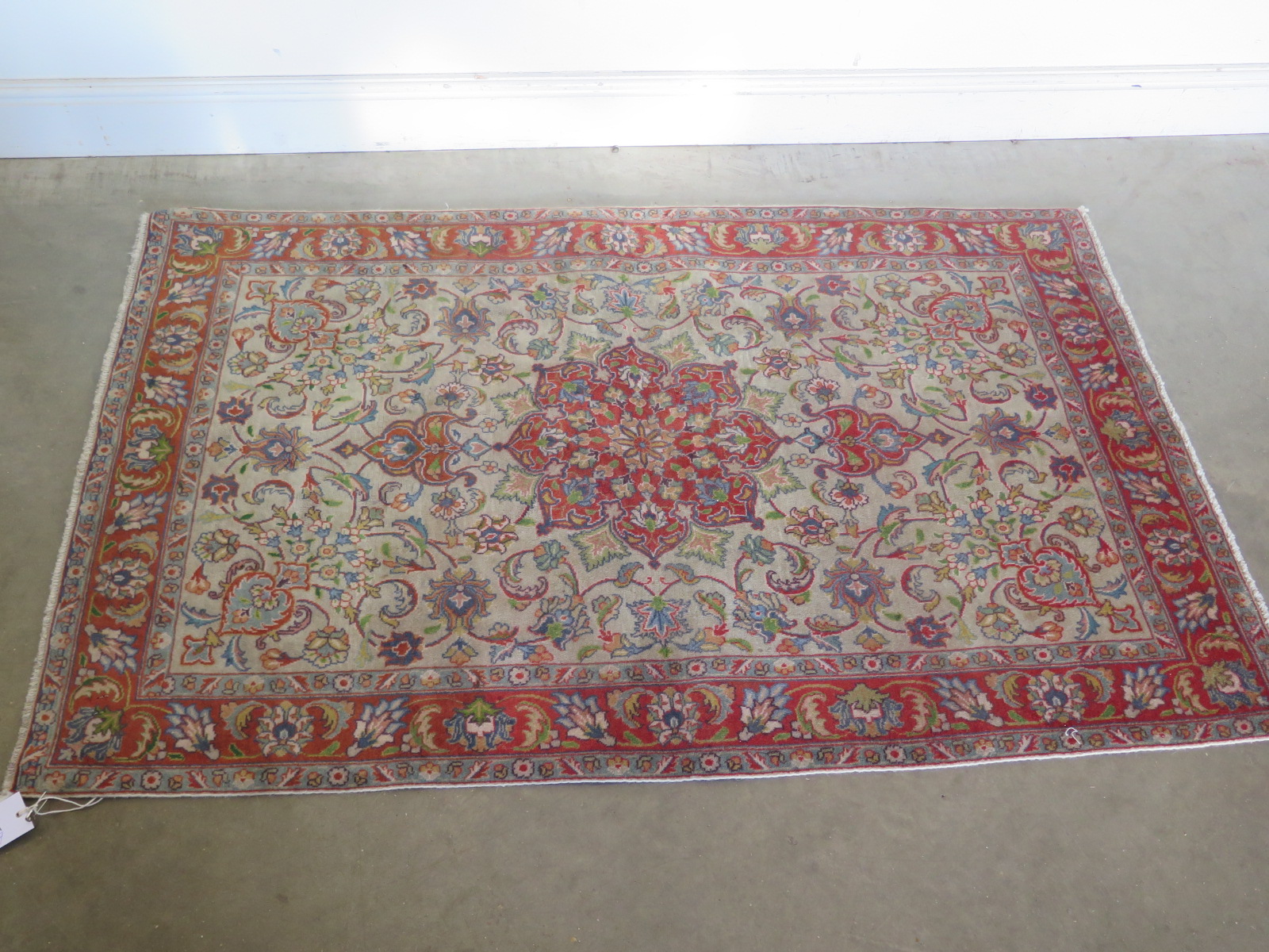 A hand knotted woollen Tabriz rug - 1.65m x 1m