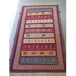A hand knotted woollen rug 2.14m x 1.3m