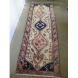 A hand knotted woollen Azarabaijan rug - some old wear and repair - 2.8m x 1m