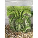 A cast stone garden plaque of a weathered green man - 43cm W x 12cm D x 54cm H