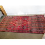 A hand knotted woollen Persian Rug - 2.55m x 1.15m