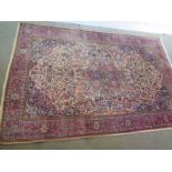 A hand knotted woollen Fine Kashan rug - 2.03m x 1.34m