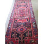 A hand knotted woollen Hamadan rug - 3.23m x 1.22m