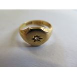 An 18ct hallmarked signet ring set with a small diamond, size N, approx 6.8 grams - some usage