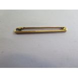 A 15ct gold bar brooch, 38mm long, approx 1.4 grams, good condition, marked 15ct