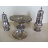 Two silver sifters, a silver anniversary dish and a sterling silver footed bowl with weighted