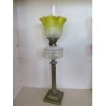 An oil lamp with clear glass reservoir and yellow etched glass shade, 77cm tall, in generally good