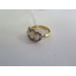 A three stone opal ring surrounded with small diamonds and an 18ct gold band, ring size Q, overall